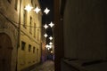 Night view of the narrowest street of Riga-Rosen Street with lanterns in the form of stars, Latvia