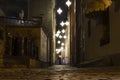 Night view of the narrowest street of Riga-Rosen Street with lanterns in the form of stars, Latvia