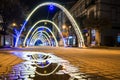 Night view of New Year or Christmas decorative arches with bright lights during winter holidays in Ivano-Frankivsk city, Ukraine.