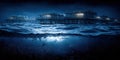 Night view of offshore platforms surrounded by waves and illuminated by soft lights Royalty Free Stock Photo