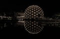 Night view of an old Atlantis building complex with lighted cinesphere theater standing in lake at Ontario Place