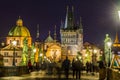 Night view of Old Town Bridge Tower and background of Church of St Francis Seraph at the bank of River Vltava, view from the