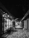 Night view of oriental style market street in Sarajevo, Bosnia. Empty street with cozy lights and closed shops around in black and Royalty Free Stock Photo