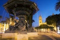 Night view of the Ornamental Pile-water fountain with bronze sculptures in the background illuminated Cathedral of