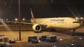 Night view of passenger plane standing in airport on the concrete paved terminal Royalty Free Stock Photo