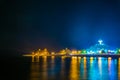 Night view of a peninsula in the Muttrah district in Muscat with the famous Al Riyam park and a watchtower on a steep cliff Royalty Free Stock Photo