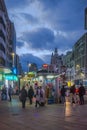 Night view of people passing near a street kiosk in Callao Madrid Spain