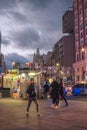 Night view of people passing near a street kiosk in Callao Madrid Spain