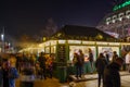 Night view of people on street around stalls of Christmas market