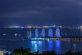 Night view of the Phoenix island in the Sanya city with bright multi-colored illumination buildings, structures and ships. Sanya Royalty Free Stock Photo