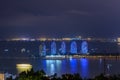 Night view of the Phoenix island in the Sanya city with bright multi-colored illumination buildings, structures and ships. Sanya Royalty Free Stock Photo