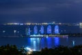 Night view of the Phoenix island in the Sanya city with bright multi-colored illumination buildings, structures and ships. Sanya Royalty Free Stock Photo