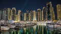 Dubai Marina towers and yachts in Dubai at night timelapse hyperlapse Royalty Free Stock Photo