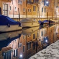 Night view of a reflected facade at the water surface