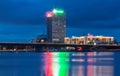 The night view of Riga modern buildings with scenic water reflections in Daugava river waters, Latvia. Royalty Free Stock Photo