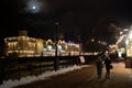 Night view of the river embankment in Rosa Khutor with walking tourists