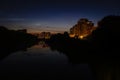 Night view of riverscape with modern blocks of flats partially reflected on the surface of water. Royalty Free Stock Photo