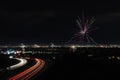 Night view of a road with bright traffic lights trails under the fireworks sky on July 4th, US Royalty Free Stock Photo