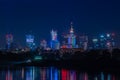 Night view on the Warsaw city buildings with lights reflection in the river. Royalty Free Stock Photo