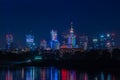 Warsaw / Poland - October 7.2018. Night view on the downtown city buildings with colorful lights reflection in the river. Royalty Free Stock Photo
