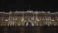 Night view of scenic illuminated architecture of Saint Petersburg city center, majestic Winter Palace with people