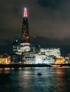 Night view of The Shard reflected in the Thames river in London. Long exposure shot