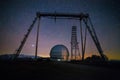 Night view. A special astrophysical observatory and a crane against the background of the starry sky and Caucasian mountains Royalty Free Stock Photo