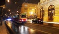 A night view of the speedy red tram rail transportation in prague