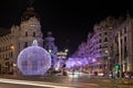 Night view of the street Grand Via and Metropolis hotel building in Madrid decorated for Christmas Royalty Free Stock Photo