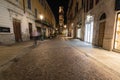 Night view of a street in Parma city center leading to a bell towers