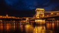 Night View Of Szechenyi Bridge. Famous Chain Bridge Of Budapest. Beautiful lighting and reflection in the Danube River. Royalty Free Stock Photo