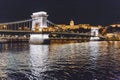 Szechenyi Chain Bridge that spans the Danube between Buda and Pest. Royal Castle at the opposite bank of the Royalty Free Stock Photo