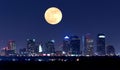 Night view of Tampa Florida skyline with huge full moon over buildings