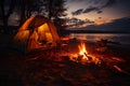 Night view of tent with campfire on the edge of a lake