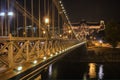 Night view to constraction of the Chain Bridge across river Danube in Budapest. Royalty Free Stock Photo