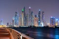 Night view to Dubai iconic skuscrappers panorama. Amazing illumination of the buildings reflected in the Gulf Royalty Free Stock Photo