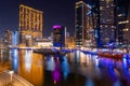 Night view to Dubai Marina panorama, reveals Pier 7 and boats. Luxury skyscrapers represent modern Dubai.