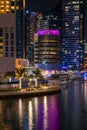 Night view to Dubai Marina skyline, reveals Pier 7 and boats. Luxury destination for tourists and residents. Royalty Free Stock Photo