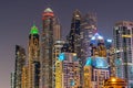 Night view to iconic skyscrapers skyline of Dubai Marina. Amazing illumination of the buildings. Royalty Free Stock Photo