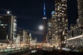 Night view of Toronto city skyline illuminated by a full moon in the sky in Canada Royalty Free Stock Photo