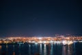 Night view toward Varna, Bulgaria. Seascape with reflection of city lights in the sea water