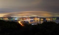 Night view of traffic and fog moving over suspension bridge