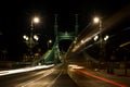 Night view of tram and cars crossing Liberty Bridge in Budapest, Hungary Royalty Free Stock Photo