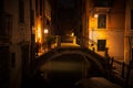 Night view of Venice with a small bridge in the yellow light of lanterns Royalty Free Stock Photo