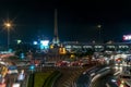 Night view of Victory Monument in the Ratchathewi district of Bangkok, Thailand, with a lot of traffic in the roundabout