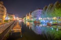 Night view of waterfront of a channel passing through the old town of Strasbourg, France