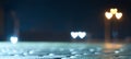 View of the night street after rain on a background of blurry lights in the shape of a heart, website background