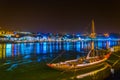 night view of a wooden boat used for transport of wine anchoring along riverside of Douro in Porto, Portugal Royalty Free Stock Photo