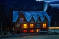 Night view of wooden snowy house