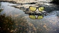 Night vision glasses with the water reflection covered by the natural background view